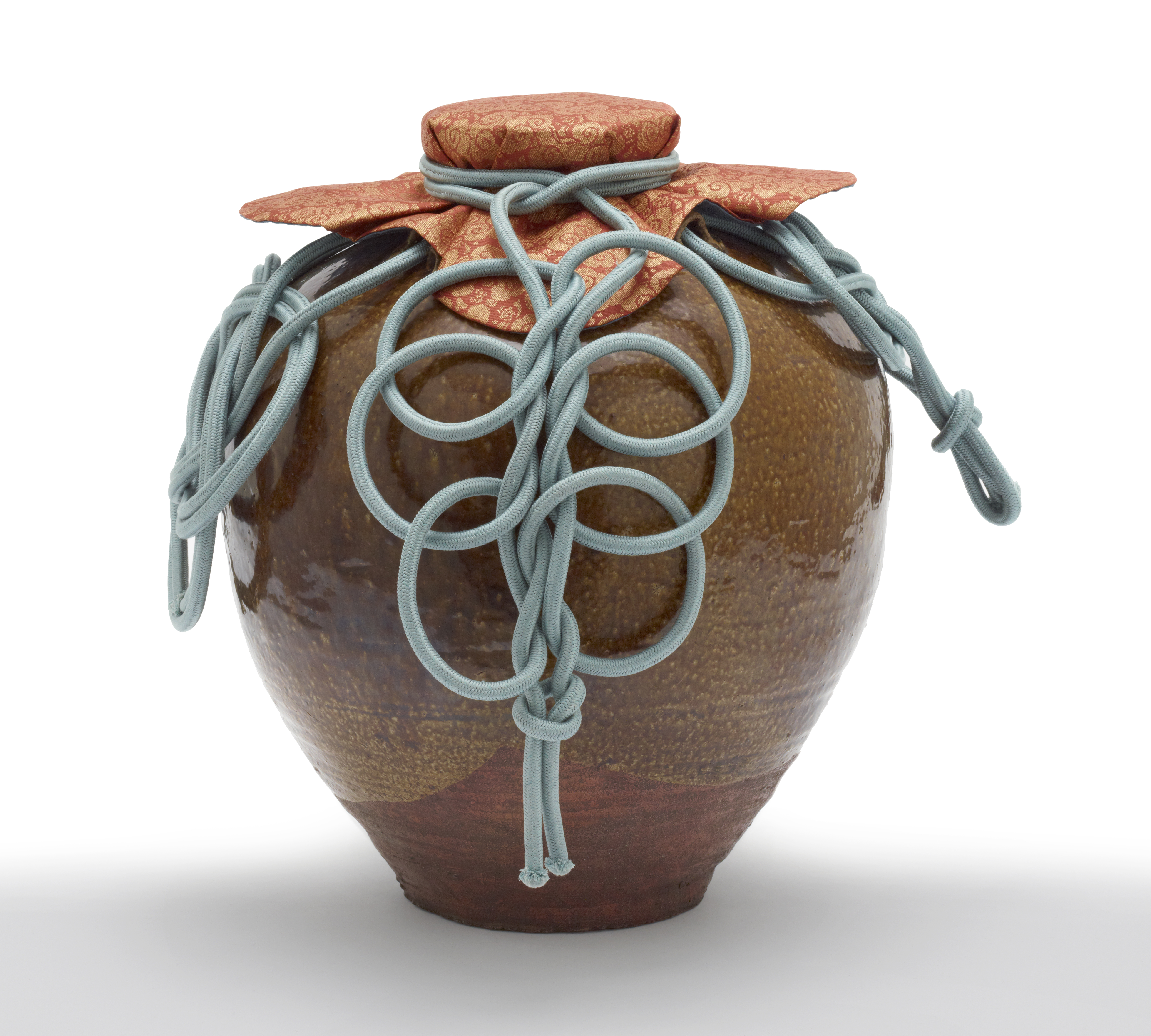 The tea-leaf storage jar (chatsubo) named Chigusa is dressed for display with a fabric mouth covering and blue decorative cords.
